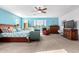 Spacious main bedroom with blue walls, a ceiling fan, and large windows at 21256 E Waverly Dr, Queen Creek, AZ 85142