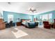 Spacious main bedroom with blue walls, a ceiling fan, and large windows at 21256 E Waverly Dr, Queen Creek, AZ 85142