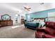 Comfortable main bedroom featuring a ceiling fan, a sitting area, and ample natural light at 21256 E Waverly Dr, Queen Creek, AZ 85142