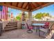 Outdoor kitchen with a built-in grill, and unique decor, located steps away from the sparkling pool with rock waterfall at 21256 E Waverly Dr, Queen Creek, AZ 85142