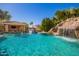 Lush pool with a slide, swim-up bar, waterfall, and manicured tropical landscaping for ultimate relaxation at 21256 E Waverly Dr, Queen Creek, AZ 85142