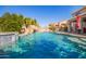 Backyard pool with a rock waterfall feature and lush landscaping, creating a serene oasis at 21256 E Waverly Dr, Queen Creek, AZ 85142