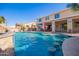 Stunning backyard pool with a stone waterfall feature and sunken bar seating, perfect for entertaining at 21256 E Waverly Dr, Queen Creek, AZ 85142