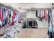 The spacious walk-in closet features plenty of shelving and rod storage for clothes at 21256 E Waverly Dr, Queen Creek, AZ 85142