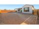Spacious dirt backyard featuring a covered patio connected to the house and a brick perimeter wall at 21287 N 272Nd Ln, Buckeye, AZ 85396