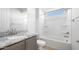 Clean bathroom showcasing a granite countertop, an undermount sink, and a shower-tub combo with a window at 21287 N 272Nd Ln, Buckeye, AZ 85396
