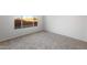 Bright bedroom featuring soft carpet, neutral walls, and a large window for ample natural light at 21287 N 272Nd Ln, Buckeye, AZ 85396