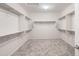 Spacious walk-in closet features built-in shelving and ample storage for organization at 21287 N 272Nd Ln, Buckeye, AZ 85396