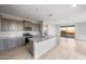 Spacious kitchen featuring a large island, granite countertops, stainless steel appliances, and ample cabinet space at 21287 N 272Nd Ln, Buckeye, AZ 85396