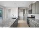 Modern kitchen with granite countertops, stainless steel appliances, a center island, and light wood-look flooring at 21287 N 272Nd Ln, Buckeye, AZ 85396