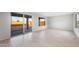 A bright open-concept living room features wood-look floors, neutral walls, and sliding glass doors at 21287 N 272Nd Ln, Buckeye, AZ 85396