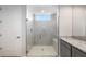 Shower featuring frameless glass doors, bench seat, white hexagon tile and a small window at 21287 N 272Nd Ln, Buckeye, AZ 85396