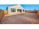 Large backyard with a blank canvas, featuring a covered patio and block fencing, ready for customization at 21288 N 272Nd Ln, Buckeye, AZ 85396