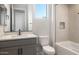 Well-lit bathroom featuring a shower/tub and a gray vanity with a white countertop at 21288 N 272Nd Ln, Buckeye, AZ 85396