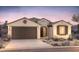 Charming single-story home with a desert-landscaped front yard and a two-car garage at 21288 N 272Nd Ln, Buckeye, AZ 85396