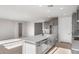 Spacious kitchen featuring stainless steel appliances, a large island, and modern cabinetry in a well-lit open-concept space at 21288 N 272Nd Ln, Buckeye, AZ 85396