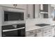 Modern kitchen featuring stainless steel appliances and quartz countertops, with a microwave and oven combination unit at 21288 N 272Nd Ln, Buckeye, AZ 85396