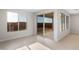 Bright, spacious living room with large windows and sliding glass doors offering ample natural light and backyard views at 21288 N 272Nd Ln, Buckeye, AZ 85396