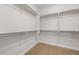 Empty walk-in closet with shelving for organization and storage at 21288 N 272Nd Ln, Buckeye, AZ 85396