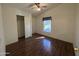 Bedroom featuring wood floors, ceiling fan, closet, and a bright window at 2233 E Behrend Dr # 85, Phoenix, AZ 85024