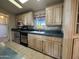 Well lit kitchen boasts tile floors, stainless steel appliances and plentiful cabinet space at 2233 E Behrend Dr # 85, Phoenix, AZ 85024