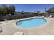 Community pool featuring clear water, a stone surround, and ample seating for relaxing by the poolside at 2233 E Behrend Dr # 85, Phoenix, AZ 85024