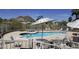 Community pool area features several lounge chairs and a mountain view at 2233 E Behrend Dr # 85, Phoenix, AZ 85024
