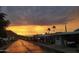 Street view showcases vibrant sunset reflecting on the road, surrounded by neatly kept mobile homes at 2233 E Behrend Dr # 85, Phoenix, AZ 85024