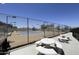 Community tennis court, surrounded by seating, perfect for matches and social play at 2233 E Behrend Dr # 85, Phoenix, AZ 85024