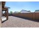 Gravel backyard with a block wall and view of neighboring houses in the distance at 22463 E Rosa Rd, Queen Creek, AZ 85142