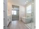 Bright bathroom with tiled floors featuring a tub and glass shower and a view of the bedroom at 22463 E Rosa Rd, Queen Creek, AZ 85142