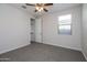 Bedroom features a ceiling fan, a window, and a large walk-in closet at 22463 E Rosa Rd, Queen Creek, AZ 85142