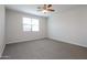 Spacious bedroom features a ceiling fan and a window letting in natural light at 22463 E Rosa Rd, Queen Creek, AZ 85142