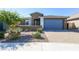 Beautiful single-story home featuring a blue garage door and desert landscaping at 22463 E Rosa Rd, Queen Creek, AZ 85142