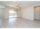 Spacious living room featuring tile floors, ceiling fan, and access to backyard patio at 22463 E Rosa Rd, Queen Creek, AZ 85142