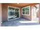 Covered patio with sliding glass door to the house and concrete flooring at 22463 E Rosa Rd, Queen Creek, AZ 85142