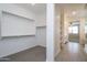 Large walk-in closet with carpeted floors and a view to the bathroom with shelving at 22463 E Rosa Rd, Queen Creek, AZ 85142