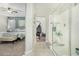 Bright bathroom features a glass walk-in shower and leads into a bedroom, providing a serene and functional space at 2424 S 235Th Dr, Buckeye, AZ 85326