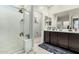 Well-lit bathroom featuring a walk-in shower and double sink vanity at 2424 S 235Th Dr, Buckeye, AZ 85326