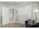 Inviting bedroom features a closet, cozy chair, and ample natural light offering a comfortable retreat at 2424 S 235Th Dr, Buckeye, AZ 85326
