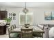 Charming dining room with seating for six, a modern light fixture, and natural light at 2424 S 235Th Dr, Buckeye, AZ 85326