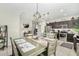 Dining room featuring tile flooring with a view into the kitchen and stainless steel appliances at 2424 S 235Th Dr, Buckeye, AZ 85326