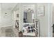 Inviting entryway features stylish decor, comfortable bench with pillows and clear sightlines into multiple rooms within the home at 2424 S 235Th Dr, Buckeye, AZ 85326