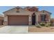 Charming single-story home with a two car garage, desert landscaping, and a tile roof at 2424 S 235Th Dr, Buckeye, AZ 85326