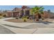 Charming single-story home with desert landscaping and a two car garage, complemented by a tile roof at 2424 S 235Th Dr, Buckeye, AZ 85326