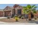 Single-story home showcasing desert landscaping, a paved driveway, and a tile roof at 2424 S 235Th Dr, Buckeye, AZ 85326