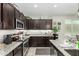Modern kitchen featuring granite countertops, stainless steel appliances, and ample cabinet space at 2424 S 235Th Dr, Buckeye, AZ 85326