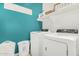 Well-organized laundry room features modern machines and ample storage and a bright, practical space for household chores at 2424 S 235Th Dr, Buckeye, AZ 85326