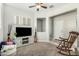 Cozy living room features a neutral color palette, an entertainment center, and plush seating providing a relaxing atmosphere at 2424 S 235Th Dr, Buckeye, AZ 85326