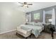 Bright bedroom featuring neutral walls, a ceiling fan, carpet flooring and a decorative bench at 2424 S 235Th Dr, Buckeye, AZ 85326